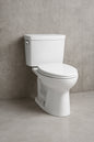 Drake Modern 10 in. Rough In Two-Piece 1.28 GPF Single Flush Elongated Toilet in Cotton White, Seat Included